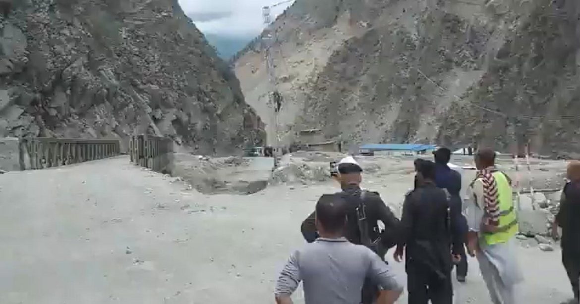 Locals watch as bridge gets swept away at Uchaar Nullah near Karakoram Highway. — Twitter Screengrab/@sherryrehman