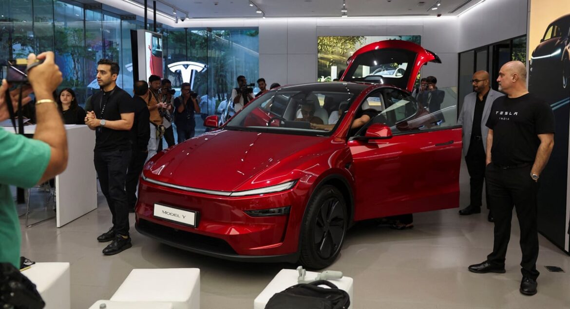 Media personnel take pictures and videos of the TESLA Model Y car at Indias first Tesla showroom in Mumbai, India, July 15, 2025. — Reuters