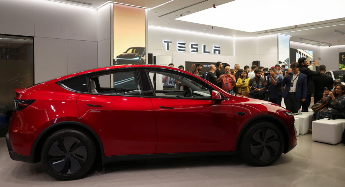 Media personnel take pictures and videos of the TESLA Model Y car at Indias first Tesla showroom in Mumbai, India, July 15, 2025. — Reuters