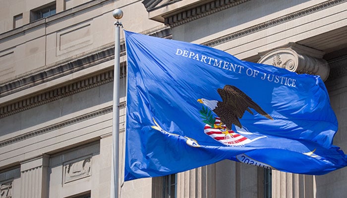 US Justice Dept pulls extremism research from website The image shows the flag of Department of Justice fluttering at its building. — DOJ/File