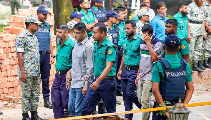 Bangladesh court detains army officers for landmark trial Police personnel escort detained army officers to the International Crimes Tribunal court in Dhaka on October 22, 2025, over charges of crimes against humanity. — AFP
