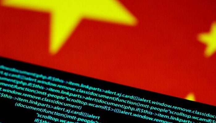 China says US waged cyberattacks on national time centre Computer code is seen on a screen above a Chinese flag in this July 12, 2017 illustration photo. — Reuters/File