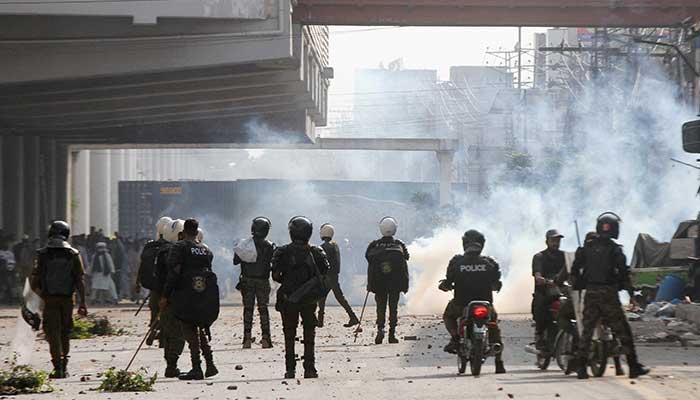 Federal cabinet ‘approves’ Punjab govt’s plea to ban TLP after Police officers stand as they use tear gas to disperse supporters of Tehreek-e-Labbaik Pakistan (TLP) during a solidarity march for Gaza in Lahore, Pakistan, October 10, 2025. — Reuters