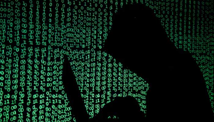 NCCIA set for major surgery amid reports of alleged cybercrime A hooded man holds a laptop computer as cyber code is projected on him in this illustration picture taken on May 13, 2017. — Reuters