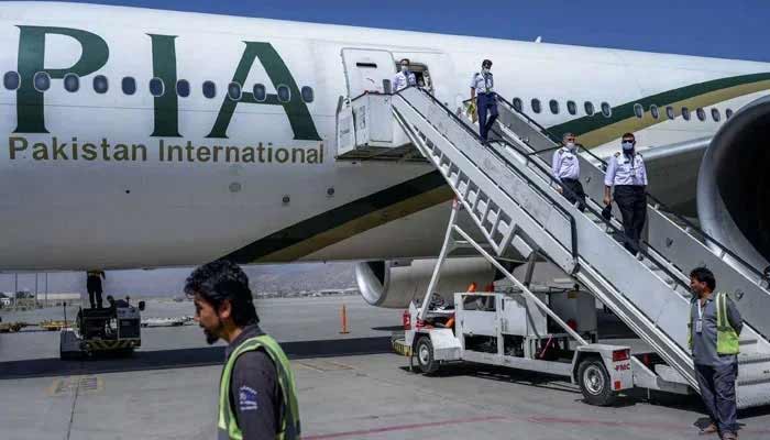 PIA privatisation to be completed by December, Senate panel told Crew members disembark from a Pakistan International Airways (PIA) flight at Kabul Airport, Afghanistan, September 13, 2021. — AFP