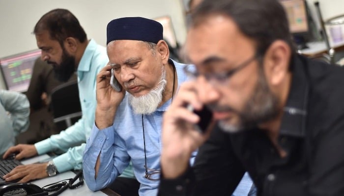 PSX declines amid profit-taking ahead of rollover week A Pakistani stockbroker monitors share prices at the Pakistan Stock Exchange in Karachi, April 8, 2025. — INP