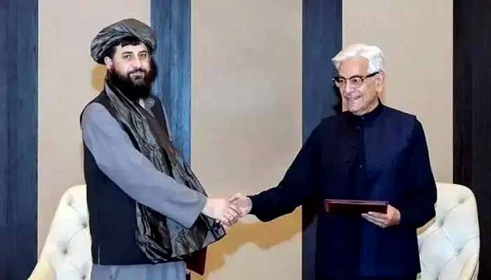Pakistan, Afghan Taliban regime agree on continuation of ceasefire Defence Minister, Khawaja Muhammad Asif (right), shakes hands with his Afghan counterpart Mullah Mohammad Yaqoob Mujahid, following the signing of a ceasefire agreement in Doha, Qatar, October 19, 2025. — Reuters