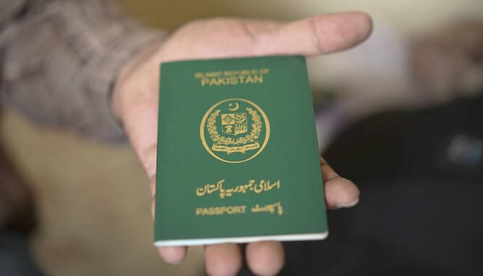 Pakistan debunks another false Indian media claim on Israel policy This photo taken on November 3, 2018, shows a man holdong a Pakistani passport in Bangkok, Thailand. — AFP