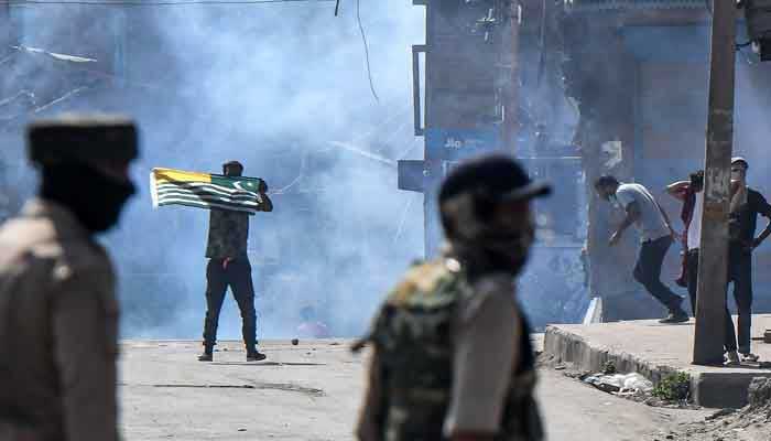 Pakistan reaffirms unwavering support for Kashmiris, demands just resolution of A protester (C-L) waves a Kashmiri flag during clashes with government forces in Batamaloo area of Srinagar on September 17, 2020 — AFP/Files