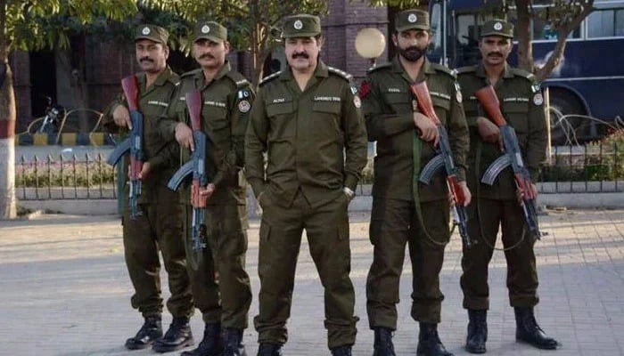 Punjab okays tough measures to curb extremism, enforce state writ Punjab police personnel posing for the camera outside a police station. — APP/File