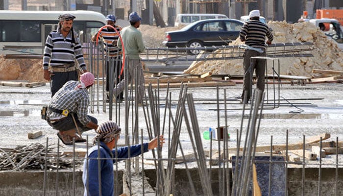 Saudi Arabia bars employers from charging domestic workers any fees Laborers work at a construction site in the Saudi capital Riyadh. — AFP/File