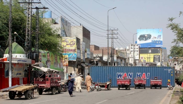 Section 144 extended for seven days across Punjab after violent Containers placed at Multan road in Lahore during Tehreek-e-Labbaik Pakistan (TLP) protest, October 16, 2025. — PPI