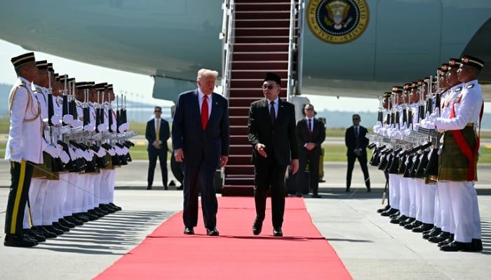 Trump kicks off Asia tour with Malaysia summit ahead of US President Donald Trump walks with Malaysian Prime Minister Anwar Ibrahim after arriving at Kuala Lumpur International Airport on October 26, 2025. — Reuters