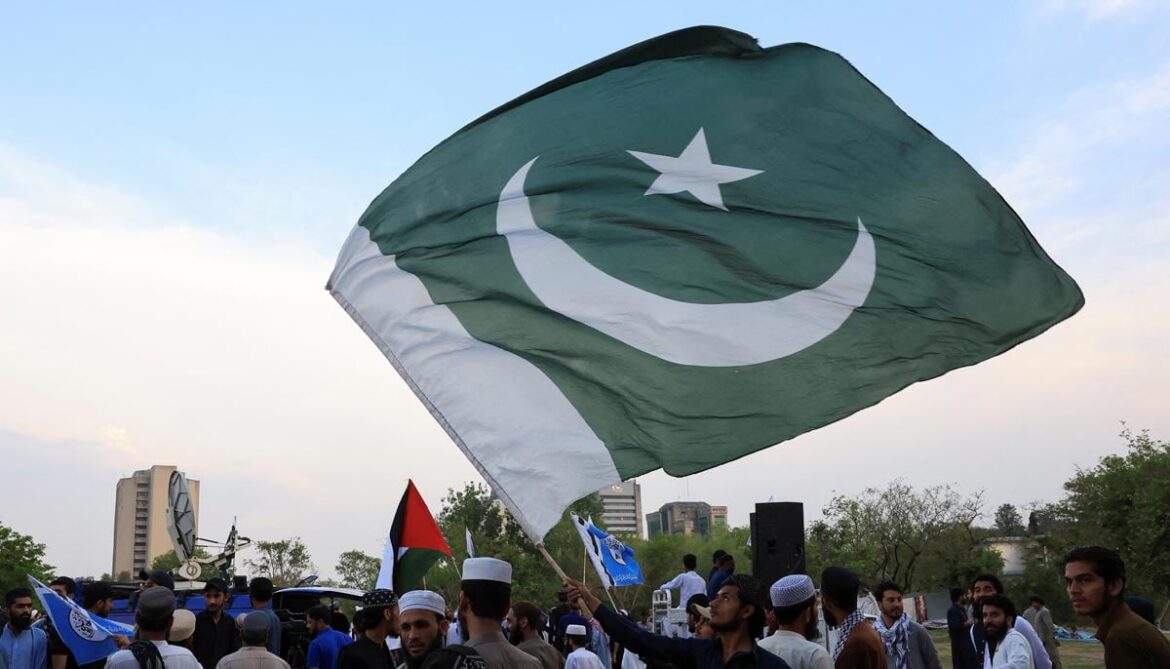 A man waves Pakistans flag as he along with others gather in support of Pakistan Army, day after the ceasefire announcement between India and Pakistan, in Islamabad, on May 11, 2025. — Reuters