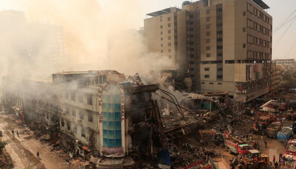 Workers remove debris following a massive fire that broke out in the Gul Plaza Shopping Mall in Karachi, January 19, 2026. — Reuter