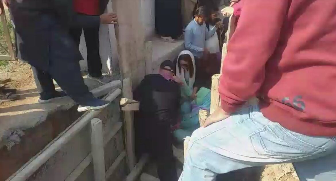 A screengrab taken from a video shows people trying to pull out Noreen Niyazi from under-construction sewerage line. — Geo News