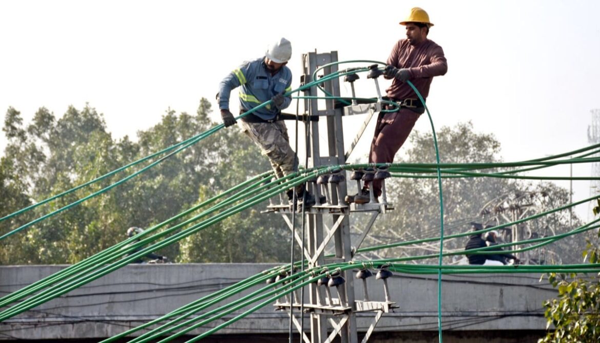 LESCO workers are repairing and laying new electrical wires on poles to restore power in Lahore on February 10, 2026. — APP