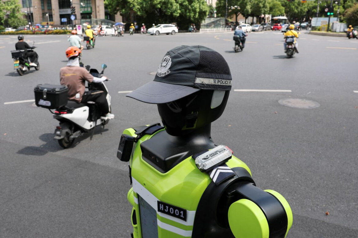A humanoid robot traffic police officer developed by SUPCON stands on duty on a street in Hangzhou, Zhejiang province, China, July 21, 2026. REUTERS