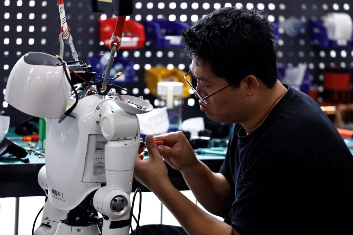 FILE PHOTO: An engineer works on a Tiangong Omni humanoid robot in the research and testing area of the Beijing Humanoid Robot Innovation Center, also known as X-Humanoid, in Beijing, China, September 4, 2026. REUTERS