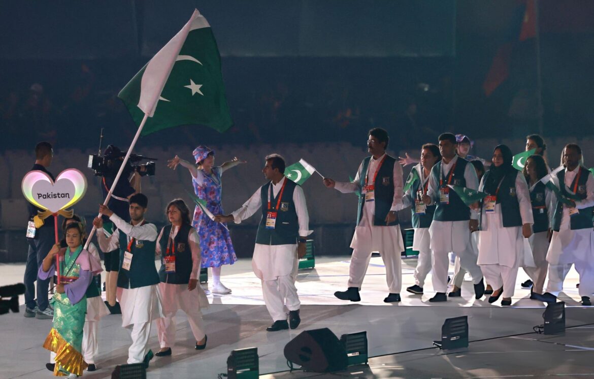 Members of Pakistan's contingent wave national flag during a march-past at the opening ceremony of the 20th Asian Games at Nagoya. Photo: AFP