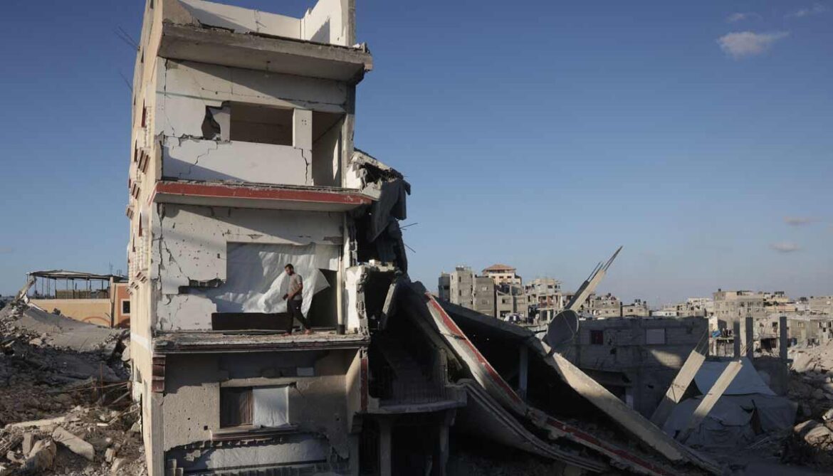 A displaced Palestinian man stands on the balcony of a heavily damaged building being used as a shelter in Khan Yunis in the southern Gaza Strip on September 19, 2026. — AFP