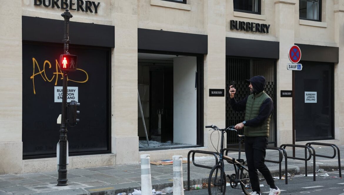 A man takes photos of a vandalised Burberry store, the day after clashes during a national day of demonstrations against the cost of living and rising fuel prices, in Paris, France, October 18, 2026. — Reuters