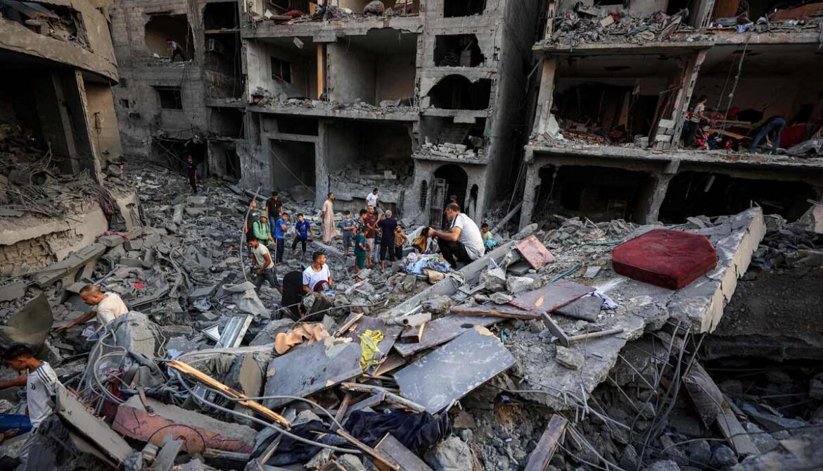People search the rubble of a collapsed building following overnight Israeli airstrikes in Gaza City on October 9, 2026. — AFP